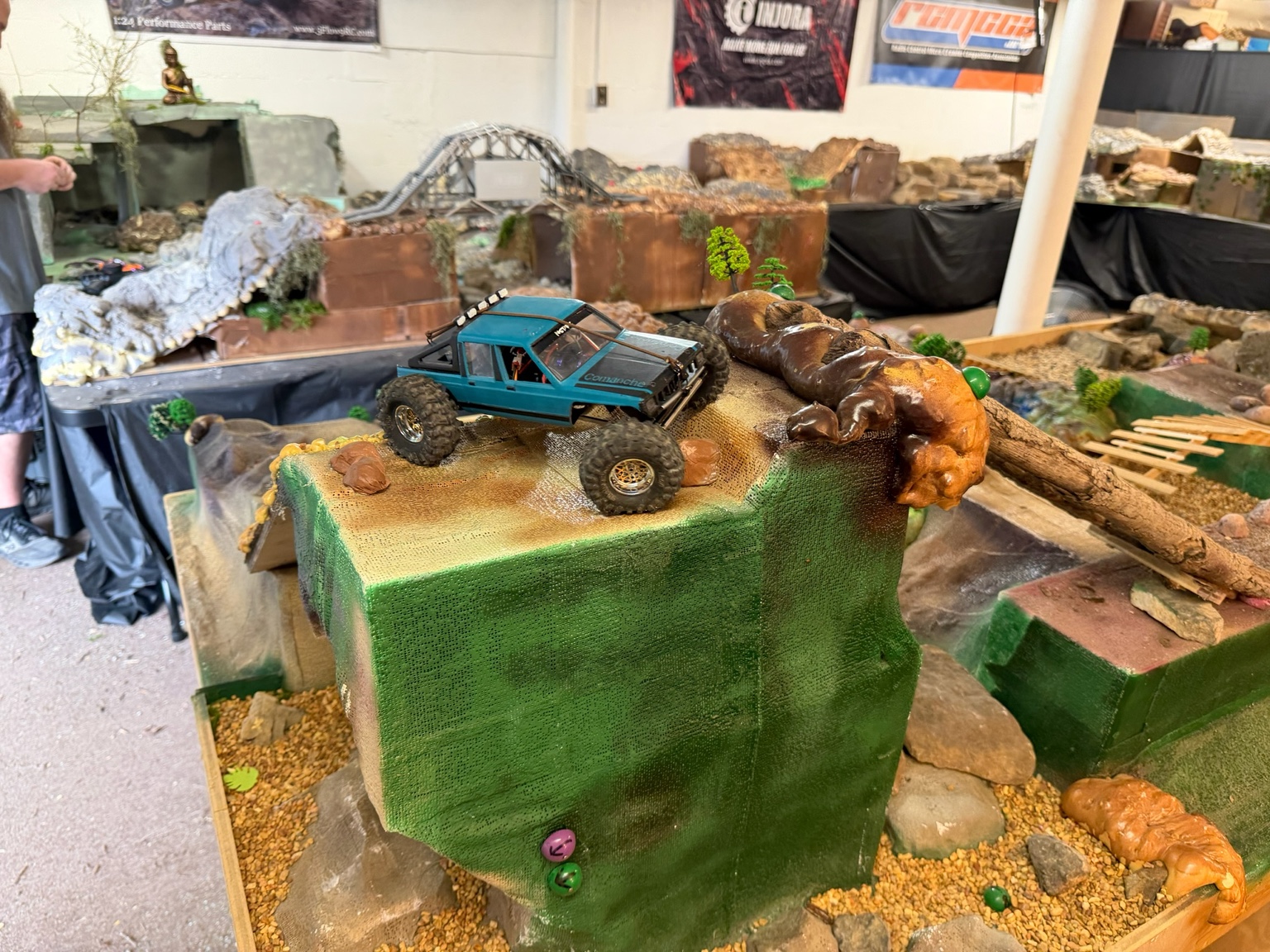 Blue RC crawler on a large indoor obstacle at the MAMC Crawling Center